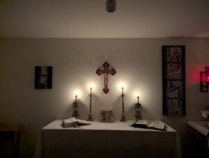 An image of the rectory chapel at Queen of Angels parish, with the candles lit and the altar prepared for Mass