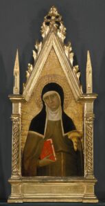 A photo of a painting of Saint Clare of Assisi within a gold frame shaped like a church steeple. Saint Clare wears her religious habit. She holds a book in one hand and a lamp in the other.