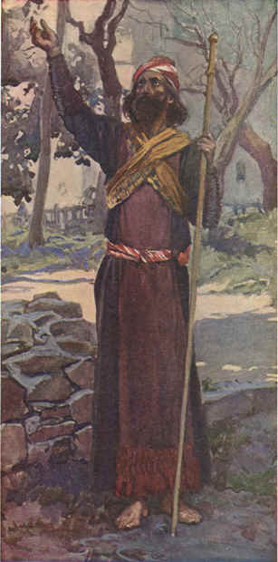 A painting of the prophet Zechariah standing robed with a staff in his hand with his other hand raised upwards as he gazes to heavens.