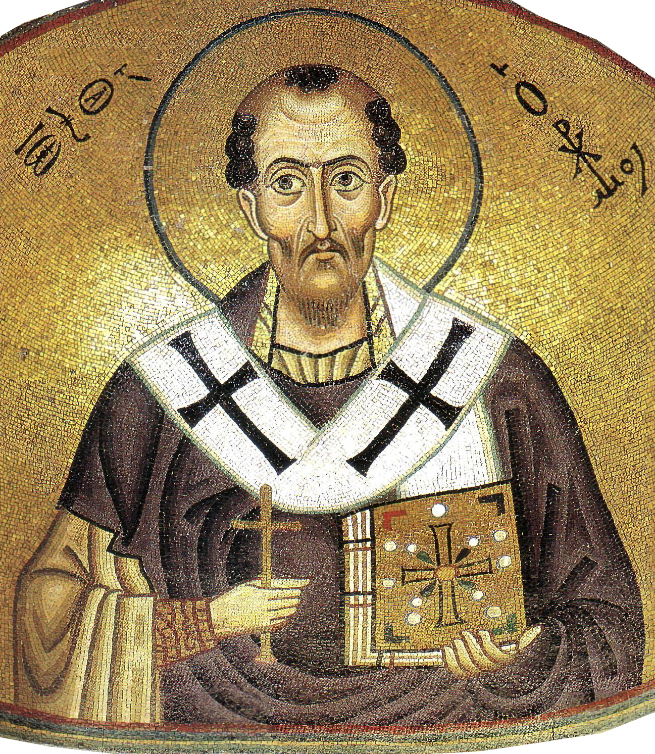 A mosaic icon of Saint John Chrysostom from the Hosios Laukas monastery in Boeotia, Greece. Robed in episcopal vestments, Saint John Chrysostom holds a cross in one hand a bible in the other, with a halo around his head.