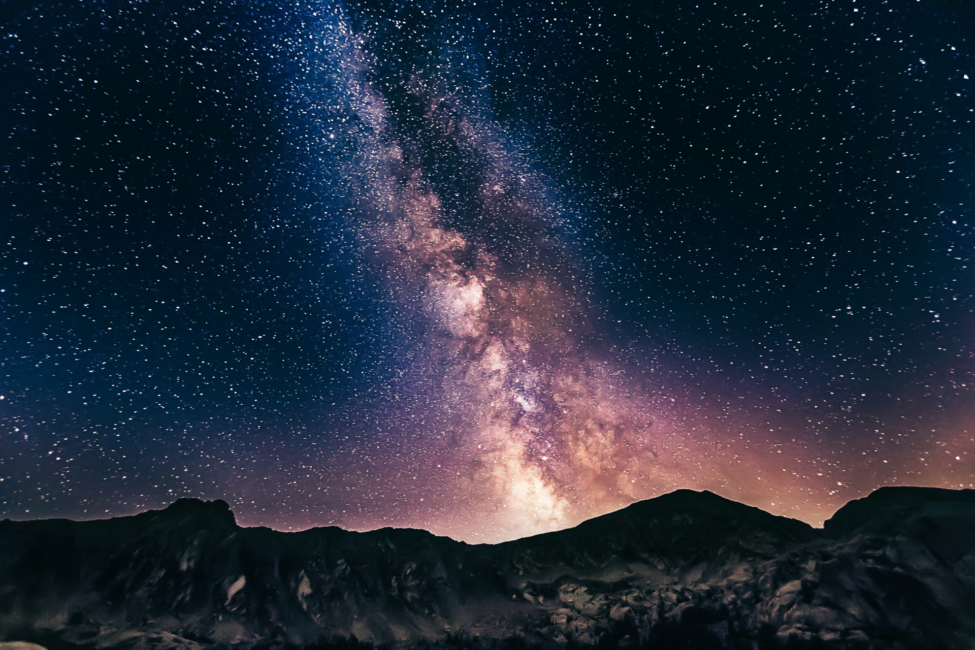 Milky way on mountans (dns-dgn-9wH624ALFQA-unsplash) A night time photo of the Milky Way galaxy over the mountains