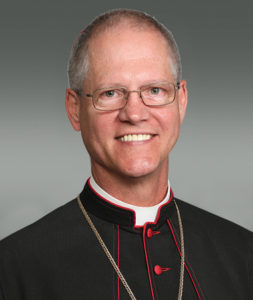 A headshot of Archbishop Paul Etienne